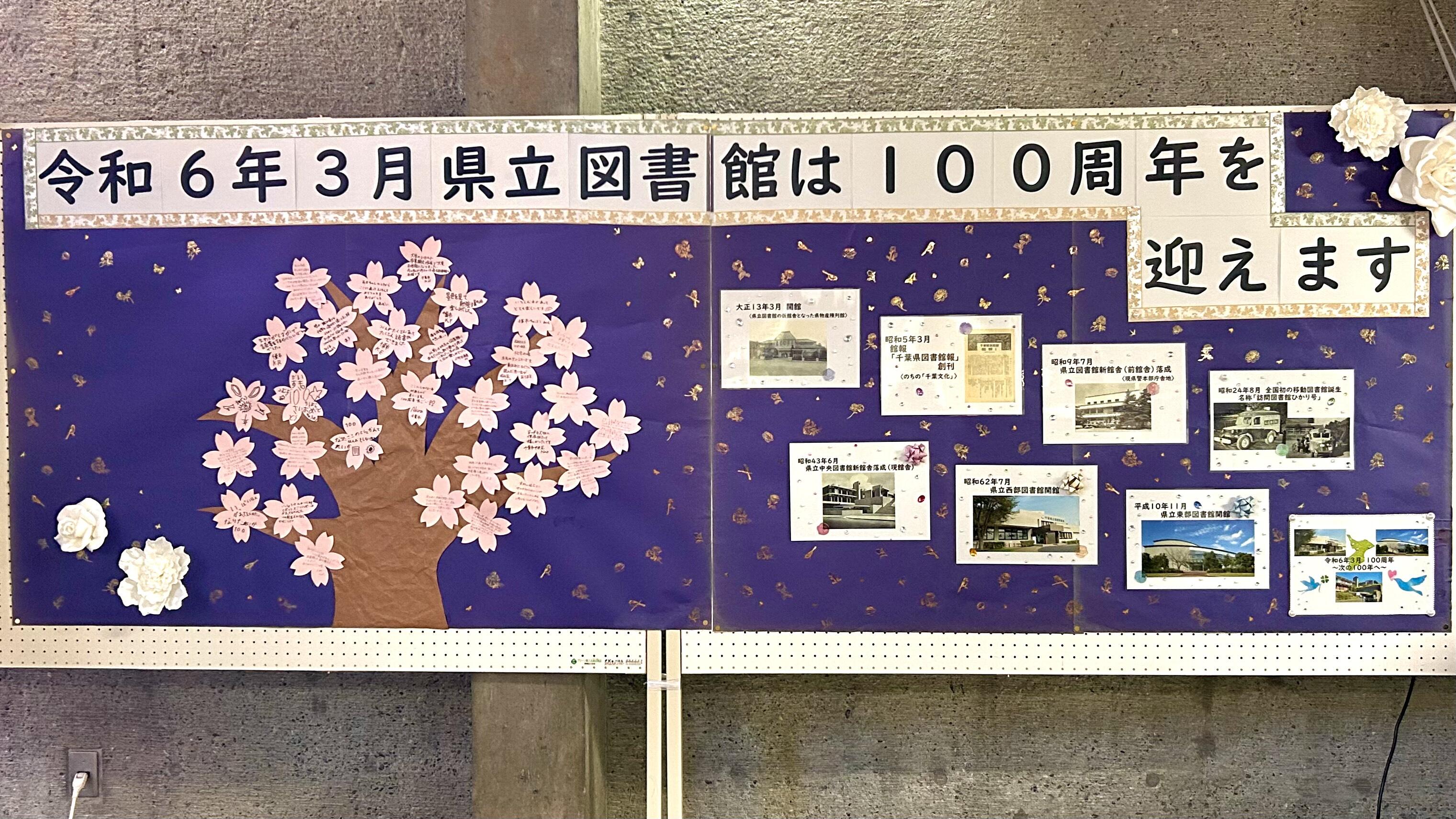 図書館の思い出・100年のあゆみを掲示している掲示板の写真。掲示板には桜の木が描かれている。桜の枝に桜の花のメッセージカードを貼りつけていく。